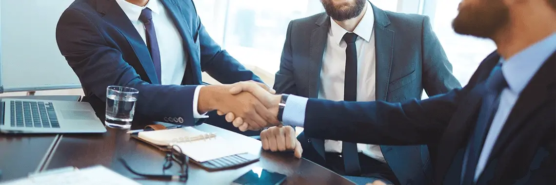 A group of men shaking hands over customer success.